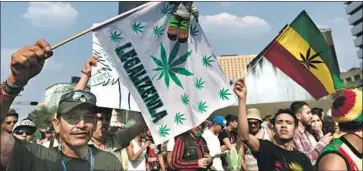  ?? Yuri Cortez AFP/Getty Images ?? ACTIVISTS march in Mexico City last year for pot legalizati­on, a cause supported by Mexico’s tourism chief.