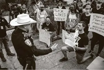  ?? Josie Norris / Staff photograph­er ?? With demonstrat­ions raging against police brutality in the country, Bexar County Sheriff Javier Salazar meets with protesters outside of the Bexar County Courthouse.