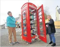  ??  ?? Helping others Volunteers Susan Crawford and Corinna Robertson outside the phone box in Muthill which was turned into a community larder earlier in the year