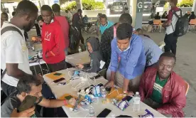  ?? California. Photograph: Daniel Trotta/Reuters ?? Asylum seekers take advantage of phone chargers and wifi to connect with family back home in Oceanside,