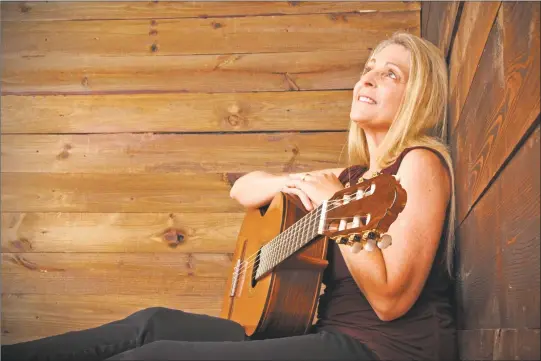  ?? Contribute­d photos ?? Guitarist and New Hartford business owner Cheryl Maust has released her first album, “Yellow Wings.”