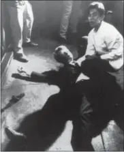  ?? BORIS YARO — LOS ANGELES TIMES VIA AP ?? In this file photo, hotel busboy Juan Romero, right, comes to the aid of Senator Robert F. Kennedy as he lies on the floor of the Ambassador hotel in Los Angeles moments after he was shot. The Los Angeles Times reported Thursday that Romero died Monday in Modesto at age 68.