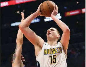  ??  ?? Denver Nuggets center Nikola Jokic AP/MICHAEL OWEN BAKER had 23 points and 11 rebounds in Saturday’s 134-115 victory over the Los Angeles Clippers. The loss knocked the Clippers out of the Western Conference playoff race.