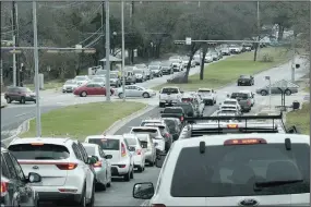  ?? (AP/Nell Carroll) ?? Traffic backs up at a residentia­l intersecti­on due to power outages Friday in south Austin after a winter storm earlier in the week.