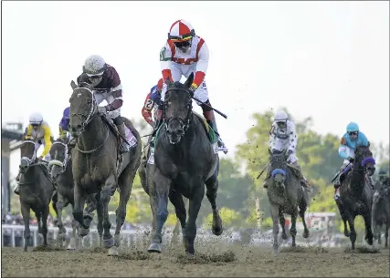  ?? AP PHOTO/JULIO CORTEZ ?? Jose Ortiz, center, atop Early Voting, edges out Joel Rosario, center left, atop Epicenter, to win during the 147th running of the Preakness Stakes horse race at Pimlico Race Course, Saturday, May 21, 2022, in Baltimore.