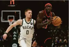  ?? Morry Gash / Associated Press ?? Toronto’s Pascal Siakam, who posted his second career triple-double, drives past Milwaukee’s Donte DiVincenzo.