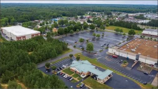  ?? The Associated Press ?? GEOFENCE: This aerial drone photo shows the Call Federal Credit Union building, front, on June 16 in Midlothian, Va. Police were able to obtain geofence search warrants, a tool being increasing­ly used by law enforcemen­t. The warrant sought location histories kept by Google of cellphones and other devices used within 150 meters (500 feet) of the bank.