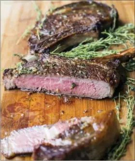  ?? SARAH CROWDER VIA ASSOCIATED PRESS ?? This photo shows ribeye steaks with thyme-garlic butter in New York.