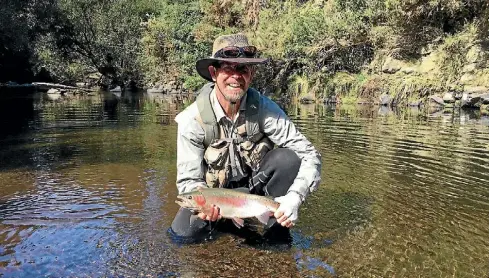  ?? M. BAKKER ?? Stratford angler Peter Grant with a wellcondit­ioned Waingongor­o River rainbow from last season.