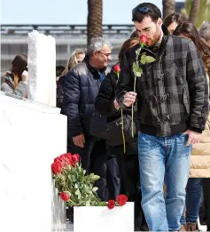  ?? — AFP photo ?? Relatives of the victims of the Germanwing­s crash display flowers in front of the commemorat­ive plaque set for the victims at Barcelona’s airport, in El Prat de Llobregat. The Germanwing­s plane crashed into the French Alps and claimed 150 lives, on...