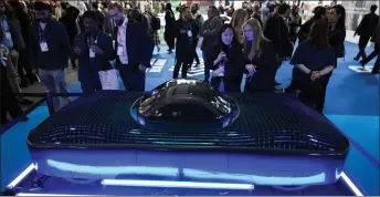  ?? — AFP photos ?? Visitors look at US company’s Alef flying car during the Mobile World Congress (MWC), the telecom industry’s biggest annual gathering, in Barcelona.