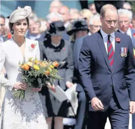  ??  ?? &gt; Catherine, Duchess of Cambridge, and Prince William, Duke of Cambridge, during a ceremony at the Commonweal­th War Graves Commission’s Tyne Cot Cemetery in Ypres yesterday