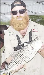  ?? (File Pic) ?? James Van Denboogaar­d holding a tiger fish weighing 1.9kg during a previous Lusip Monster Fish Competitio­n.