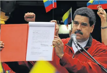  ?? Reuters ?? Election ire: Venezuela's President Nicolas Maduro shows a document during a rally at Miraflores Palace in Caracas with the details of a ‘constituen­t assembly’ to reform the constituti­on. /