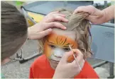  ??  ?? Jordison Lawrence, 4, took on some lion-like features while having his face painted.