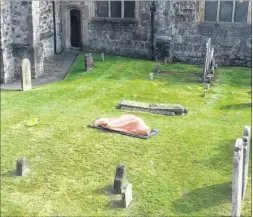  ??  ?? The ‘body’ in St Mary’s churchyard was actually someone taking a nap but passers-by wondered what was going on