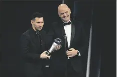  ?? MICHEL EULER AP PHOTO/ ?? Argentina’s Lionel Messi receives the Best FIFA Men’s player award from FIFA president Gianni Infantino during the ceremony of the Best FIFA Football Awards in Paris, France, on Monday.