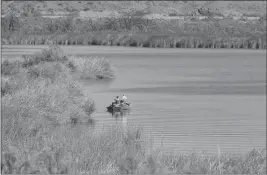  ?? SUN ?? luck in one of the many channels at Mittry Lake. On the horizon is nearby Yuma Proving Ground.