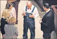  ?? Arkansas Democrat-Gazette/STATON BREIDENTHA­L ?? Rep. Mark McElroy (center), I-Tillar, talks with his colleagues Thursday before the House convenes on the final day of the special session. McElroy and other House members were allowed to wear denim for a $20 donation as part of the Do Pass for Denim...