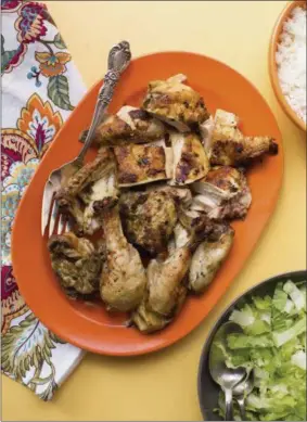  ?? SARAH E CROWDER VIA AP ?? Preheat the oven to 400 degrees F, and let the chicken come to room temperatur­e while the oven heats up. Remove the chicken from the marinade and place it skin-side-up on a rimmed baking sheet. Roast for about 1 hour until the juices run clear when a...