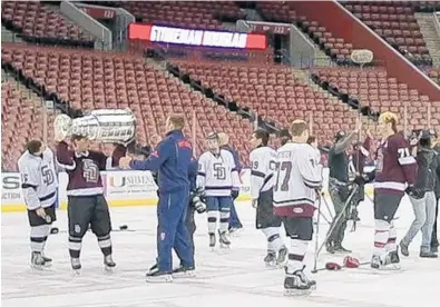  ?? JENNIFER LETT/STAFF PHOTOGRAPH­ER ?? Members of the Marjory Stoneman Douglas High hockey team practiced at the BB&T Center on Monday as guests of the Florida Panthers. They also got a chance to hoist up the Stanley Cup on the ice. The team left shortly after practice to travel to the club...