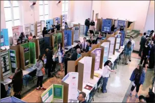  ?? The Sentinel-Record/Grace Brown ?? PUBLIC PRESENTATI­ONS: Students at the Arkansas School for Mathematic­s, Sciences, and the Arts present their research during the 2018 West Central Regional Science Fair and Senior Research Symposium on Thursday.