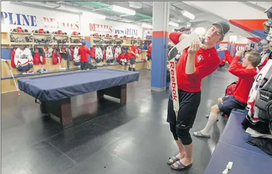  ?? Photos: Colleen De Neve/ Calgary Herald ?? Brooks Bandits goalie Devon Fordyce tapes his stick in the dressing room prior to their game against the visiting Whitecourt Wolverines.