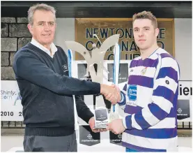  ??  ?? Newtonmore captain Steven Macdonald receives the Marine Harvest Trophy from Steve Bracken, Marine Harvest support manager.