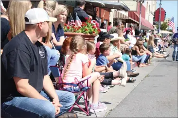  ?? PHOTOS BY COREY KIRK, THE REPORTER ?? Fairgoers patiently wait for the next float to come by at the 145th annual Dixon May Fair's annual parade, hosted by the Dixon Chamber of Commerce early Saturday afternoon.