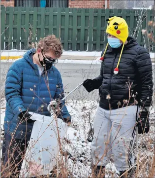  ?? BILL JONES/DAILY SOUTHTOWN PHOTOS ?? Peter Panos, left, and Cyrus Pacheco, of Boy Scout Troop 619, work together to pick up trash Monday during a Day of Service at the Sand Ridge Nature Center in South Holland.