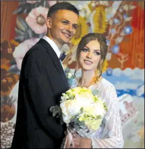  ?? NATACHA PISARENKO/ AP PHOTO ?? Denys Voznyi and Anna Karpenko pose for a photo before getting married in Kyiv, Ukraine, on June 15.