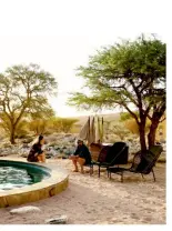  ??  ?? Design details From left: The circular sunken lounge blurs the distinctio­n between architectu­re and furniture. The guest bathroom features a stone plinth for the taps. The dining room table in the main living area is made from Namibian granite – the same rock found in the surroundin­g mountain range. Owner Swen Bachran with his partner, Katinka Bester by the pool.