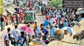  ??  ?? Rohingya refugees gather at a market as first cases of COVID-19 coronaviru­s have emerged in the area (AFP)