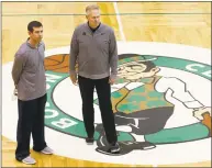  ?? Jessica Rinaldi / Getty Images ?? Celtics coach Brad Stevens, left, and GM Danny Ainge watch a 2018 practice. Ainge is back at work after recovering from a mild heart attack.