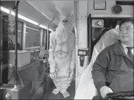  ?? BRENDAN MCDERMID / REUTERS ?? A New York transit driver looks on as an actor dressed as a yeti boards his bus last fall.