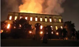  ?? Photograph: Ricardo Moraes/Reuters ?? People watch as a fire burns at the National Museum of Brazil in Rio de Janeiro on 2 September 2018.