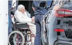  ?? FOTO: DANIEL KARMANN/DPA ?? Der emeritiert­e Papst Benedikt XVI. wird mit einem Rollstuhl in einen Bus geschoben. Der gebürtige Bayer besucht seinen schwer kranken Bruder in Regensburg.