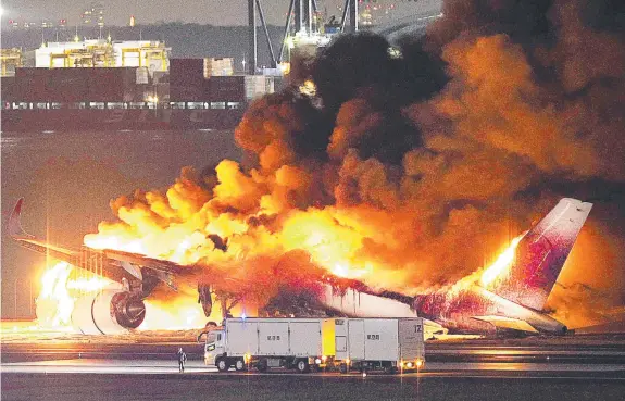  ?? Picture: JIJI PRESS / AFP ?? The Japan Airlines plane on fire on a runway of Tokyo's Haneda Airport.