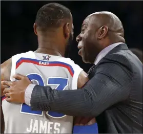  ??  ?? In this Feb. 19, 2017, file photo, former NBA player Magic Johnson reacts as he talks with Eastern Conference’s LeBron James, of the Cleveland Cavaliers, during the first half of the NBA AllStar basketball game in New Orleans. AP PHOTO/GERALD HERBERT