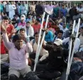  ?? — G.N.JHA ?? Physically challenged men sit on a dharna at Mandi House in New Delhi on Wednesday.