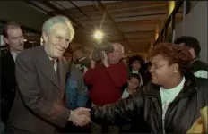  ?? ELISE AMENDOLA / AP FILE ?? Aaron Feuerstein, left, president and owner of malden mills Industries Inc., in methuen, shakes hands with workers on Jan. 11, 1996, in Lawrence.