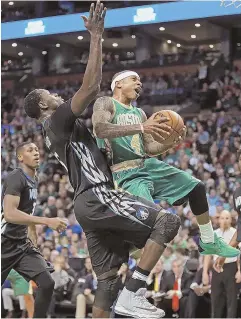  ?? STAFF PHOTO BY MATT STONE ?? SQUEEZE PLAY: Isaiah Thomas goes to the basket against Timberwolv­es forward Gorgui Dieng during the Celtics’ win last night at the Garden.