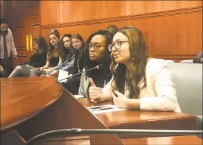  ?? Kaitlyn Krasselt / Hearst Connecticu­t Media ?? Mariam Khan, right, a Hamden High School senior and lead organizer of the Connecticu­t chapter of PERIOD, a national advocacy group pushing menstrual equity, testifies before the legislatur­e’s Public Health Committee in support of a bill that would require schools to provide free feminine hygiene products in middle and high school bathrooms across the state.