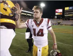  ?? RALPH FRESO — THE ASSOCIATED PRESS ?? Southern California quarterbac­k Sam Darnold (14) congratula­tes Arizona State quarterbac­k Manny Wilkins following USC’s 48-17 win on Oct. 28.