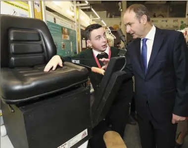  ??  ?? Jack Nagle (Killorglin Community College) explains his design to Fianna Fáil leader Micheál Martin TD at the BT Young Scientist and Technology Exhibition in the RDS, Dublin.