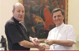  ??  ?? Bishop of Gozo, Mgr Mario Grech, handing over a cheque for €5,783.31 to Canon Simon Godfrey, chancellor of St Paul’s Anglican Pro-Cathedral