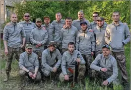  ?? ?? Fighters: Stanislav Lepko, bottom row, second from left, and Maksym Savch, back row, fifth from left, with members of their platoon in Ukraine