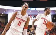  ?? Michael Wyke Associated Press ?? HOUSTON guard Nate Hinton, left, and guard DeJon Jarreau celebrate the Cougars’ win over Cincinnati.