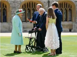  ??  ?? Receiving his knighthood from HM the Queen