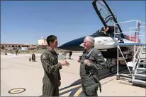 ?? DAMIAN DOVARGANES / AP ?? Air Force Secretary Frank Kendall, right, talks to Col. James Valpiani, Commandant, USAF TPS, after Kendall’s test flight of the X-62A VISTA aircraft against a humancrewe­d F-16 aircraft Thursday in the skies above Edwards Air Force Base.